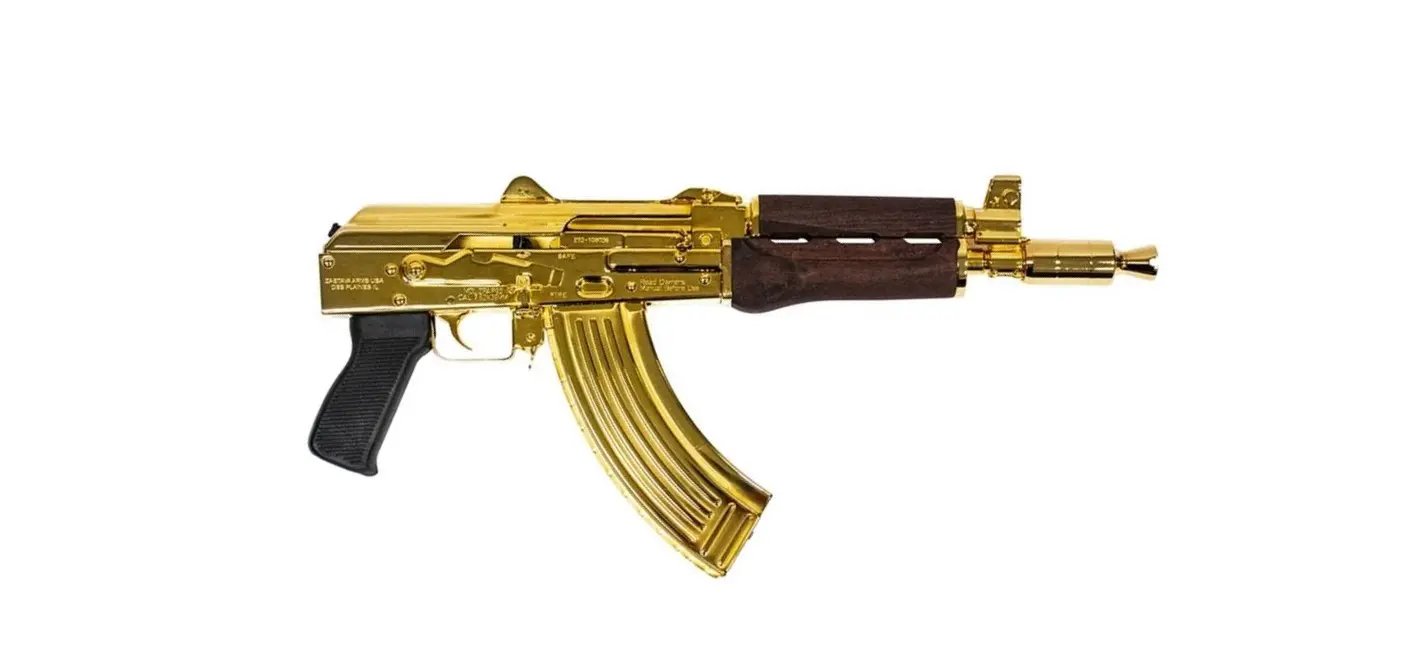 Golden AK-47 replica firearm on white background.